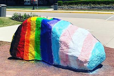 Kissing Rock with the Pride Flag painted on it.